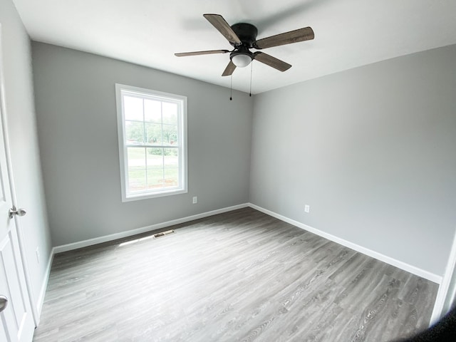 100 Wt Hardison Ave, Portland, TN 37148 - spare room featuring wood finished floors, a ceiling fan, and baseboards