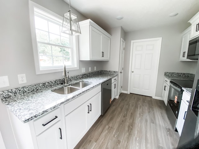 100 Wt Hardison Ave, Portland, TN 37148 - kitchen featuring a sink, appliances with stainless steel finishes, light stone counters, and wood finished floors