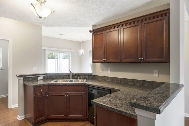 2012 Arum Ct, Spring Hill, TN 37174 - kitchen featuring a sink, dishwasher, a peninsula, wood finished floors, and a textured ceiling