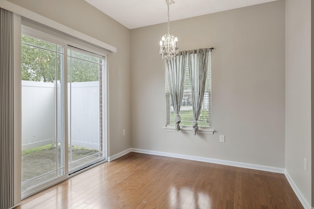 2012 Arum Ct, Spring Hill, TN 37174 - unfurnished room with wood finished floors, a chandelier, and baseboards