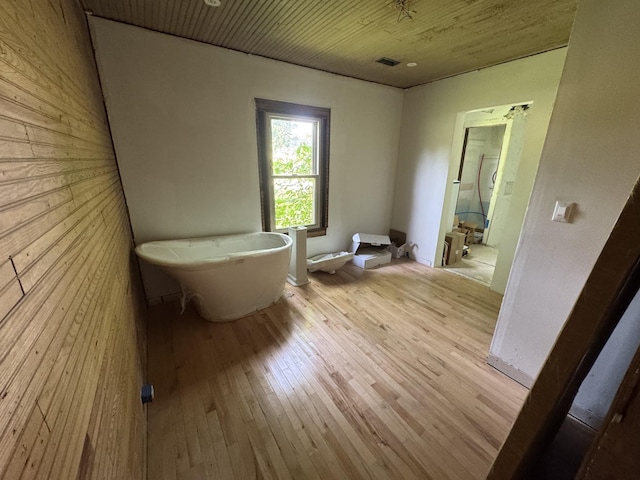 662 Happy Hollow Rd, Goodlettsville, TN 37072 - bathroom featuring wood-type flooring, wood walls, wooden ceiling, and a freestanding tub