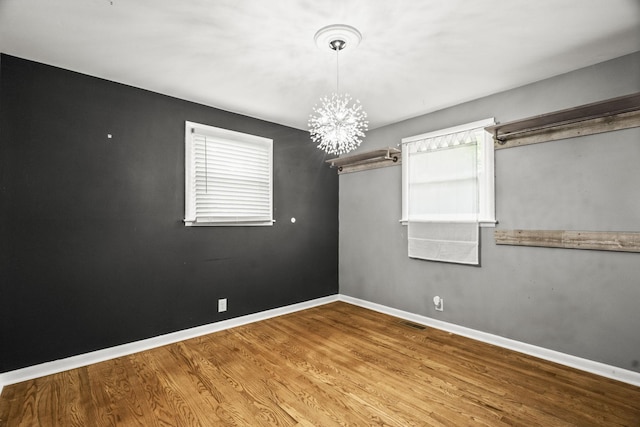 225 Nelson Dr, La Vergne, TN 37086 - unfurnished room with a chandelier, baseboards, and wood finished floors