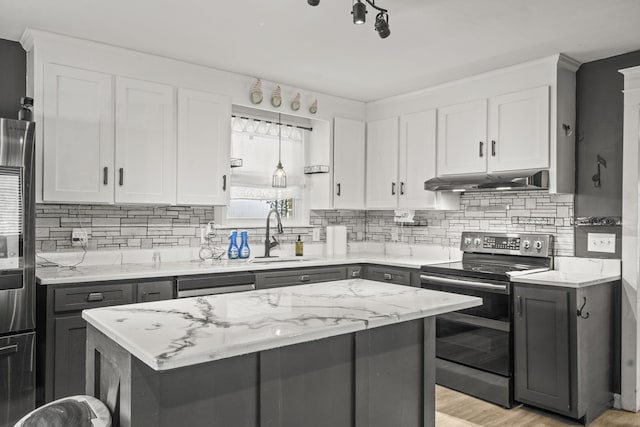 225 Nelson Dr, La Vergne, TN 37086 - kitchen with stainless steel electric stove, a sink, under cabinet range hood, and tasteful backsplash