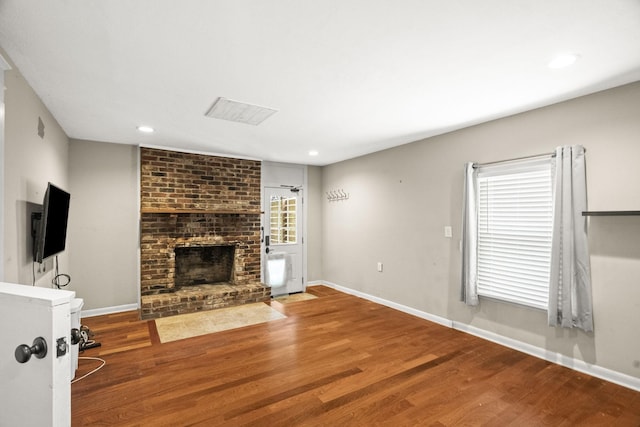 225 Nelson Dr, La Vergne, TN 37086 - unfurnished living room featuring wood finished floors, a fireplace, baseboards, and recessed lighting