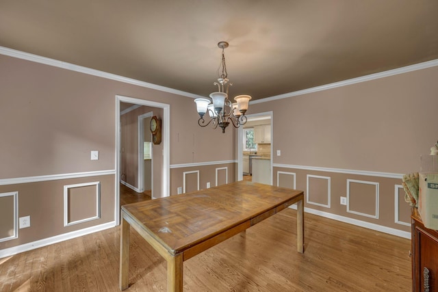 1321 Robert E Lee Ln, Brentwood, TN 37027 - dining space featuring a chandelier, wood finished floors, a wainscoted wall, and ornamental molding