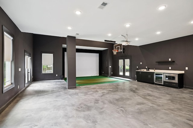 8226 Frontier Ln, Brentwood, TN 37027 - unfurnished living room with beverage cooler, finished concrete flooring, baseboards, recessed lighting, and french doors