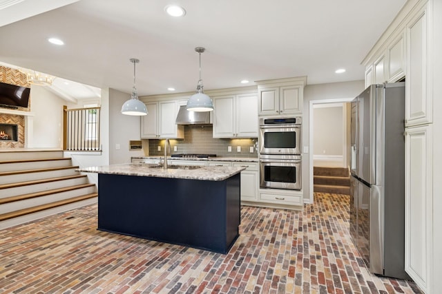 8226 Frontier Ln, Brentwood, TN 37027 - kitchen with stainless steel appliances, a sink, brick floors, backsplash, and range hood