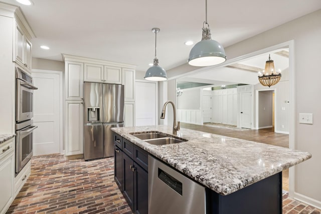 8226 Frontier Ln, Brentwood, TN 37027 - kitchen with appliances with stainless steel finishes, a sink, brick flooring, recessed lighting, and decorative light fixtures