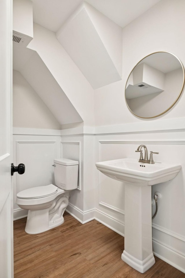 8226 Frontier Ln, Brentwood, TN 37027 - half bathroom with toilet, wood finished floors, a decorative wall, a wainscoted wall, and a sink