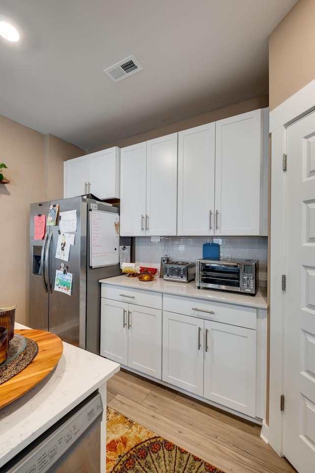 1605 Medinah Ln, Lebanon, TN 37087 - kitchen with stainless steel fridge with ice dispenser, dishwashing machine, light countertops, and white cabinets