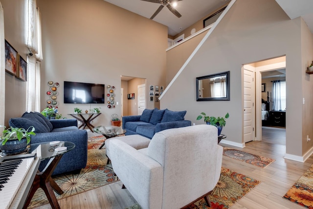1605 Medinah Ln, Lebanon, TN 37087 - living area featuring light wood-style floors, a ceiling fan, stairway, and a towering ceiling