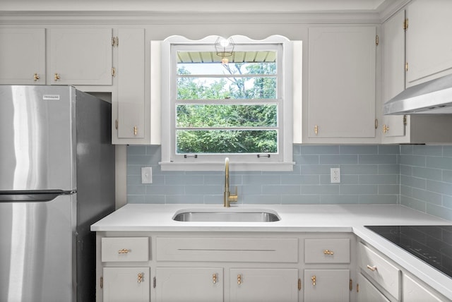 415 Jordan Rd, Clarksville, TN 37042 - kitchen featuring freestanding refrigerator, decorative backsplash, light countertops, black electric stovetop, and white cabinets