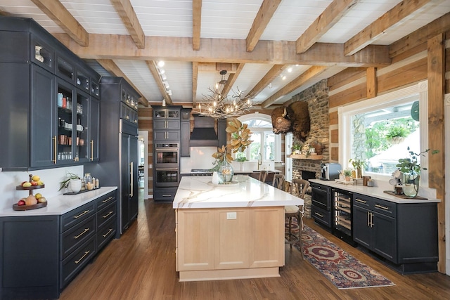 1105 Mount Pleasant Rd, Kingston Springs, TN 37082 - kitchen with beam ceiling, a center island, a chandelier, double oven, and dark wood-type flooring