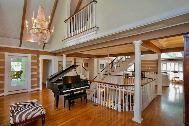 1105 Mount Pleasant Rd, Kingston Springs, TN 37082 - stairs featuring decorative columns, wood finished floors, a chandelier, a high ceiling, and beam ceiling
