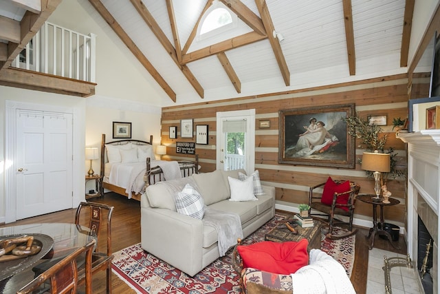 1105 Mount Pleasant Rd, Kingston Springs, TN 37082 - living area featuring wood finished floors, wood walls, beamed ceiling, high vaulted ceiling, and a fireplace with flush hearth