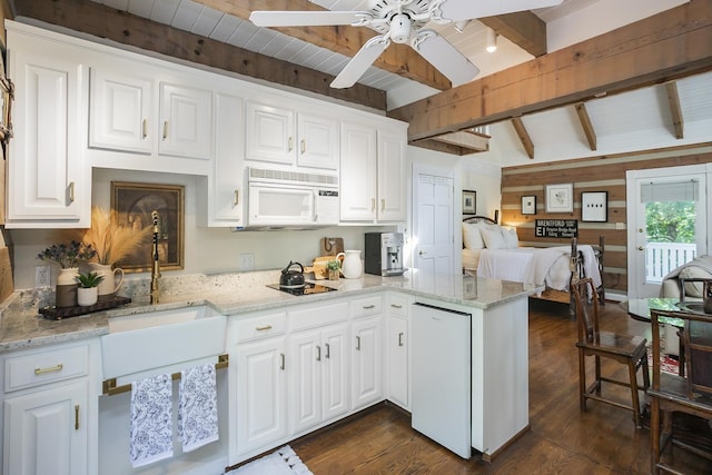 1105 Mount Pleasant Rd, Kingston Springs, TN 37082 - kitchen with white microwave, a peninsula, open floor plan, dark wood-style floors, and white cabinets