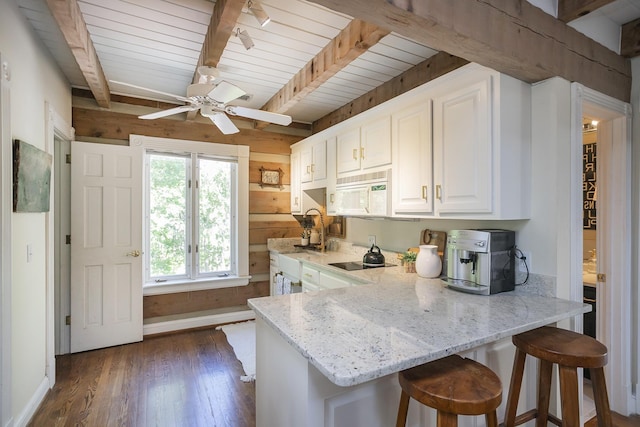 1105 Mount Pleasant Rd, Kingston Springs, TN 37082 - kitchen featuring white microwave, dark wood-type flooring, light stone counters, white cabinets, and black electric stovetop