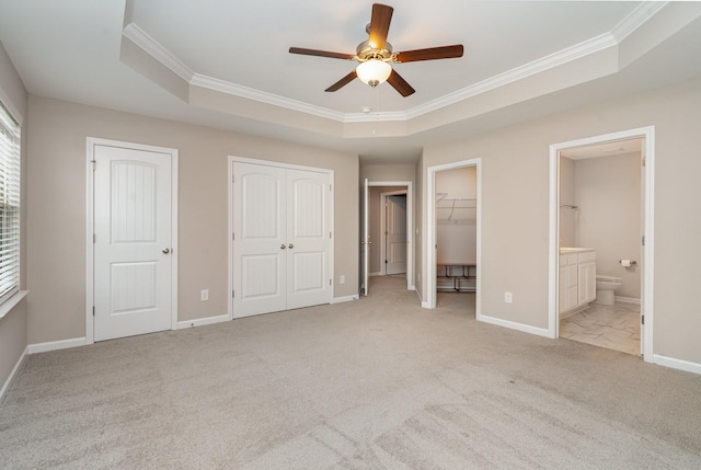 142 Rising Pvt Ln, Gallatin, TN 37066 - unfurnished bedroom featuring ornamental molding, carpet flooring, baseboards, a tray ceiling, and connected bathroom