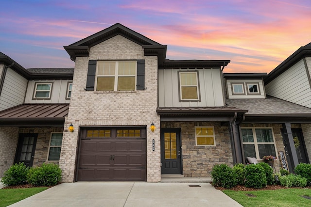 142 Rising Pvt Ln, Gallatin, TN 37066 - view of front of home with driveway, a standing seam roof, an attached garage, stone siding, and board and batten siding