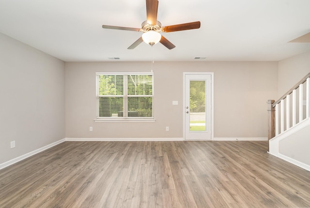 142 Rising Pvt Ln, Gallatin, TN 37066 - unfurnished room with stairs, wood finished floors, baseboards, and a ceiling fan