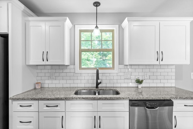 1341 Sussex Dr, Clarksville, TN 37042 - kitchen with stainless steel dishwasher, a sink, white cabinetry, and tasteful backsplash