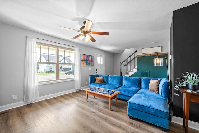 1341 Sussex Dr, Clarksville, TN 37042 - living room with stairway, ceiling fan, baseboards, and wood finished floors