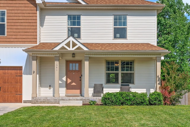 1341 Sussex Dr, Clarksville, TN 37042 - view of front facade with covered porch, a front lawn, a garage, and a shingled roof