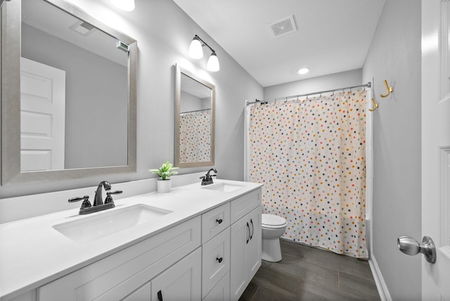1341 Sussex Dr, Clarksville, TN 37042 - bathroom with toilet, double vanity, baseboards, and a shower with curtain