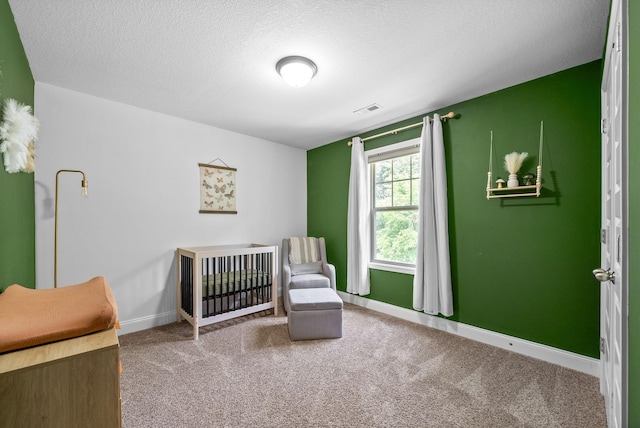 1341 Sussex Dr, Clarksville, TN 37042 - bedroom featuring carpet floors, baseboards, a nursery area, and a textured ceiling