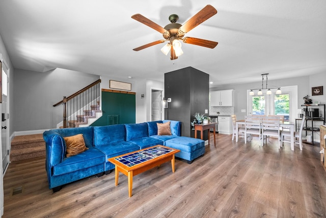 1341 Sussex Dr, Clarksville, TN 37042 - living area featuring stairs, ceiling fan, light wood-type flooring, and baseboards