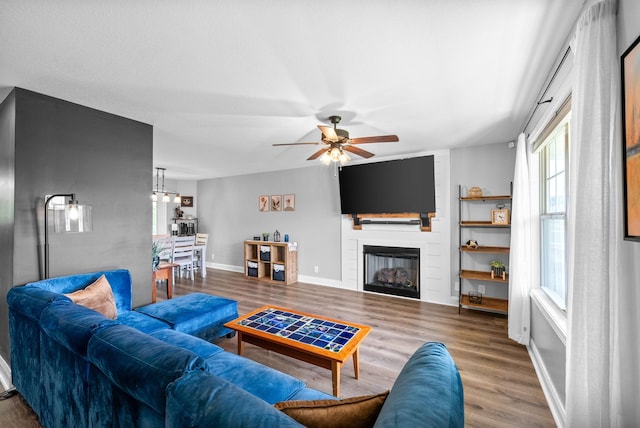 1341 Sussex Dr, Clarksville, TN 37042 - living area with wood finished floors, ceiling fan, a large fireplace, and baseboards