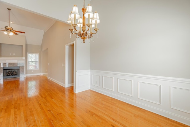 4370 Wellesley Dr, Ooltewah, TN 37363 - unfurnished dining area with a ceiling fan, a chandelier, light wood-style flooring, a fireplace, and lofted ceiling