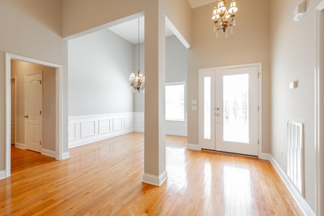 4370 Wellesley Dr, Ooltewah, TN 37363 - foyer entrance featuring a chandelier, a towering ceiling, light wood-type flooring, and baseboards