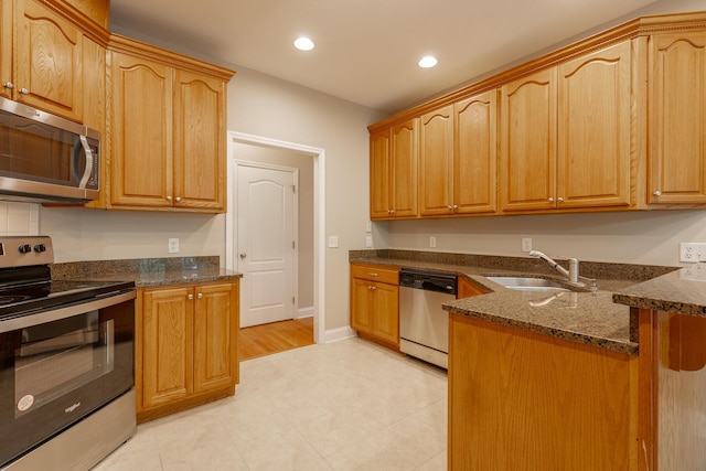 4370 Wellesley Dr, Ooltewah, TN 37363 - kitchen featuring stainless steel appliances, a sink, dark stone countertops, recessed lighting, and a peninsula