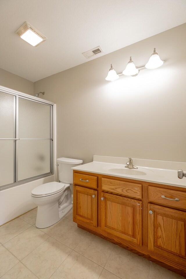 4370 Wellesley Dr, Ooltewah, TN 37363 - full bath featuring toilet, bath / shower combo with glass door, vanity, and tile patterned flooring
