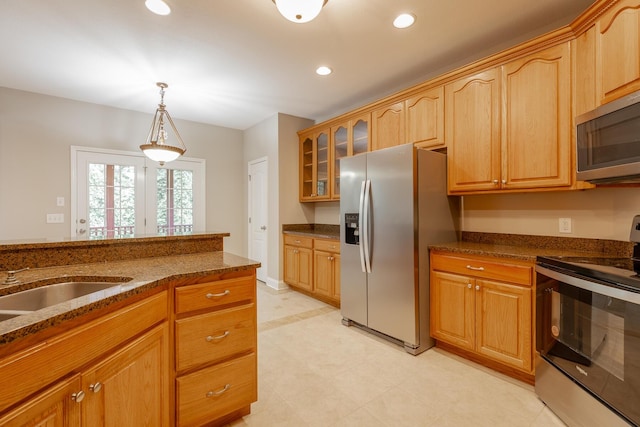 4370 Wellesley Dr, Ooltewah, TN 37363 - kitchen featuring stainless steel appliances, dark stone countertops, glass insert cabinets, recessed lighting, and hanging light fixtures