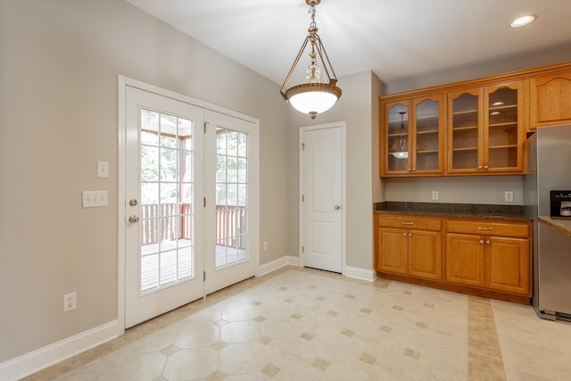4370 Wellesley Dr, Ooltewah, TN 37363 - kitchen with stainless steel refrigerator with ice dispenser, brown cabinetry, glass insert cabinets, baseboards, and recessed lighting