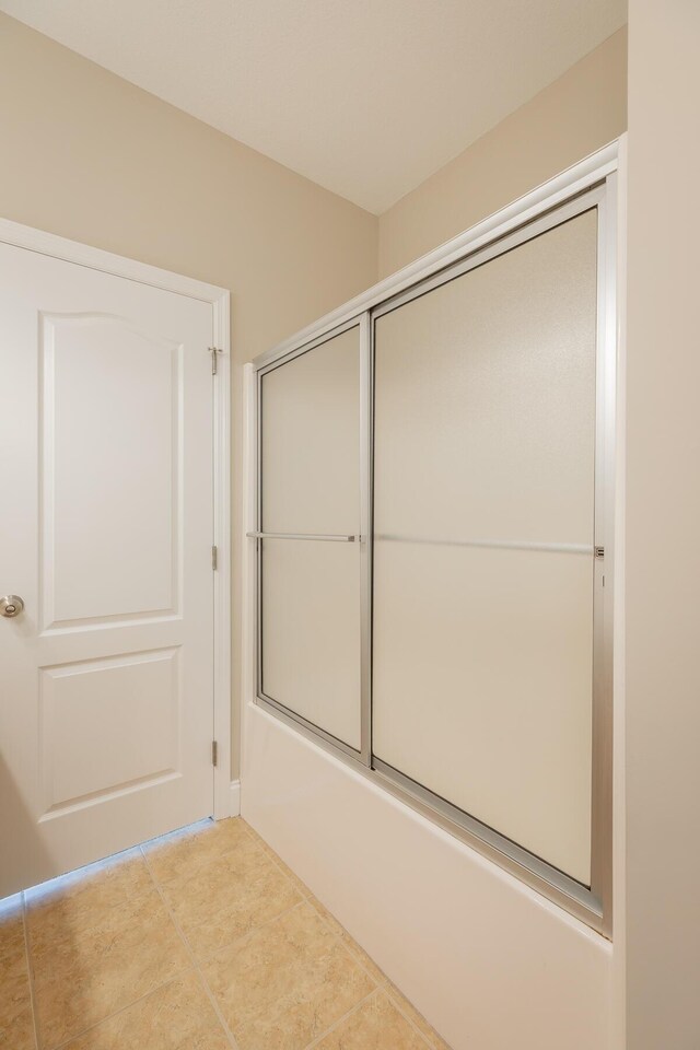 4370 Wellesley Dr, Ooltewah, TN 37363 - full bath featuring tile patterned flooring and shower / bath combination with glass door