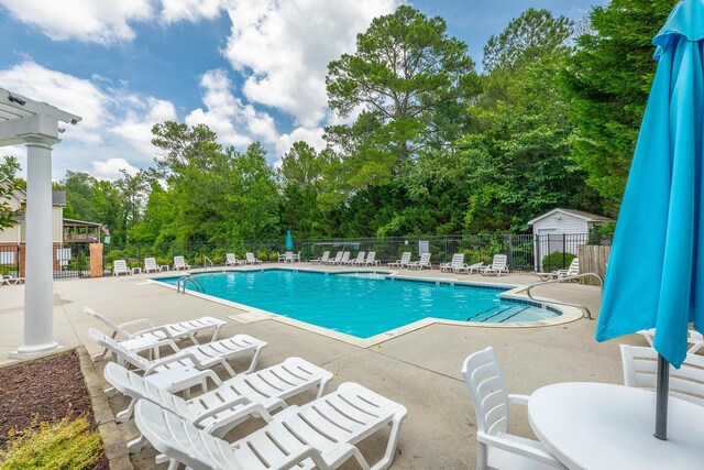 4370 Wellesley Dr, Ooltewah, TN 37363 - community pool with a patio area and view of wooded area