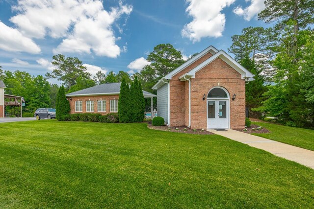 4370 Wellesley Dr, Ooltewah, TN 37363 - traditional-style home with brick siding, a front yard, and french doors