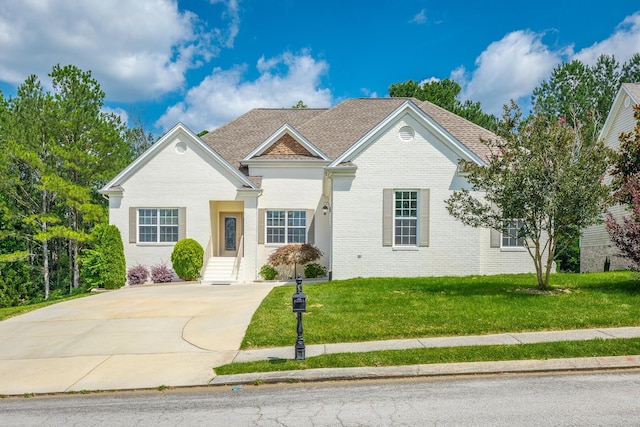 4370 Wellesley Dr, Ooltewah, TN 37363 - traditional-style house with brick siding, a front yard, and driveway