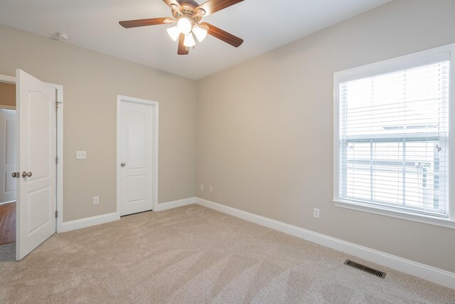 4370 Wellesley Dr, Ooltewah, TN 37363 - unfurnished bedroom featuring light carpet, multiple windows, baseboards, and ceiling fan