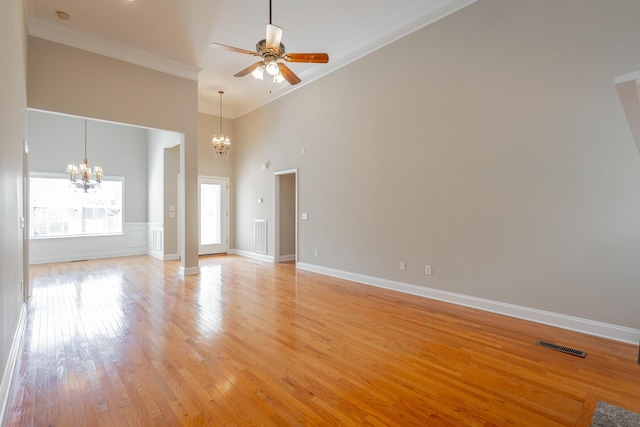 4370 Wellesley Dr, Ooltewah, TN 37363 - unfurnished living room featuring a chandelier, crown molding, a towering ceiling, ceiling fan, and light wood-style floors