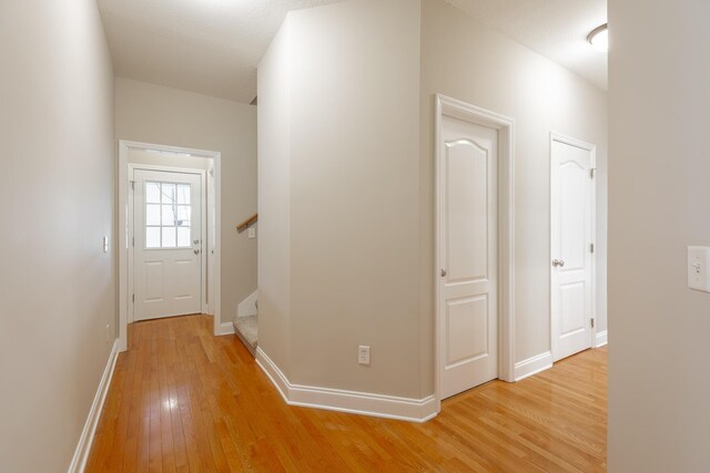 4370 Wellesley Dr, Ooltewah, TN 37363 - hall with light wood-style flooring, baseboards, and stairway