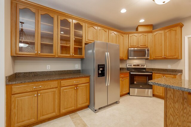 4370 Wellesley Dr, Ooltewah, TN 37363 - kitchen with appliances with stainless steel finishes, glass insert cabinets, dark stone counters, and recessed lighting