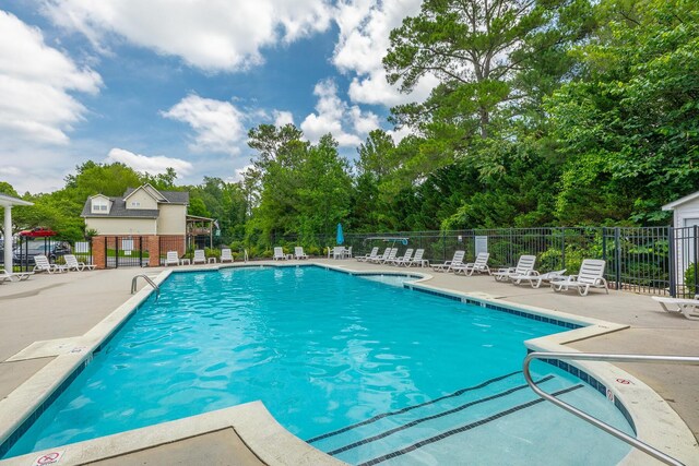 4370 Wellesley Dr, Ooltewah, TN 37363 - community pool with a patio area and view of wooded area