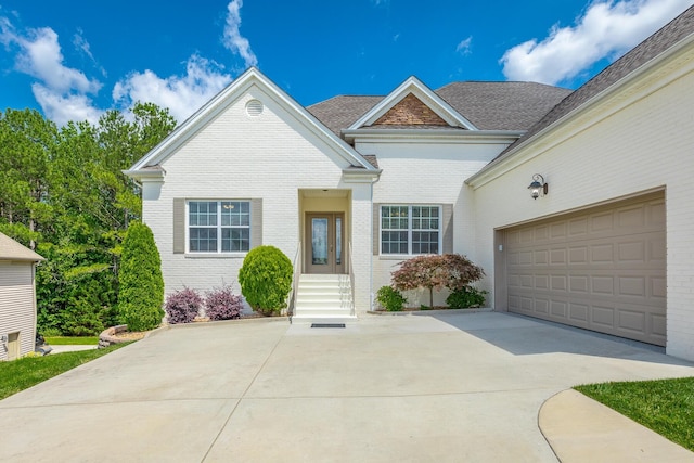 4370 Wellesley Dr, Ooltewah, TN 37363 - view of front of house featuring brick siding, driveway, and an attached garage