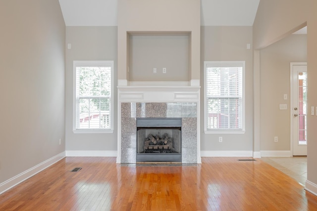 4370 Wellesley Dr, Ooltewah, TN 37363 - unfurnished living room with hardwood / wood-style flooring, plenty of natural light, vaulted ceiling, and baseboards