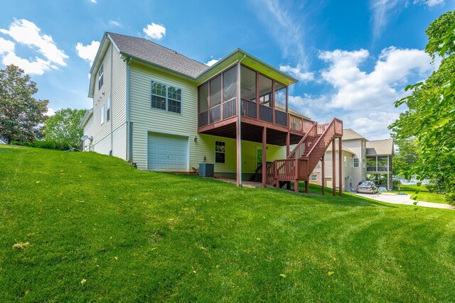 4370 Wellesley Dr, Ooltewah, TN 37363 - rear view of property featuring a sunroom, an attached garage, stairway, and a lawn