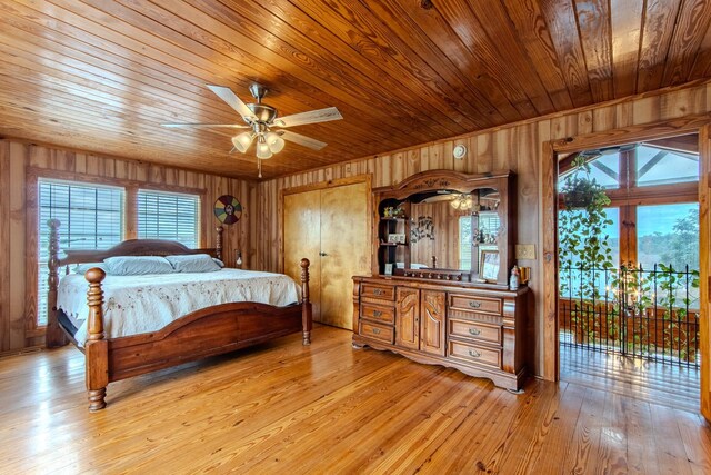230 Silver Water Ln, Counce, TN 38326 - bedroom with access to exterior, wooden walls, multiple windows, wood ceiling, and light wood-style floors